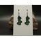 Machine embroidered earrings of the word Lucky in green with black border. Black hypoallergenic hooks.